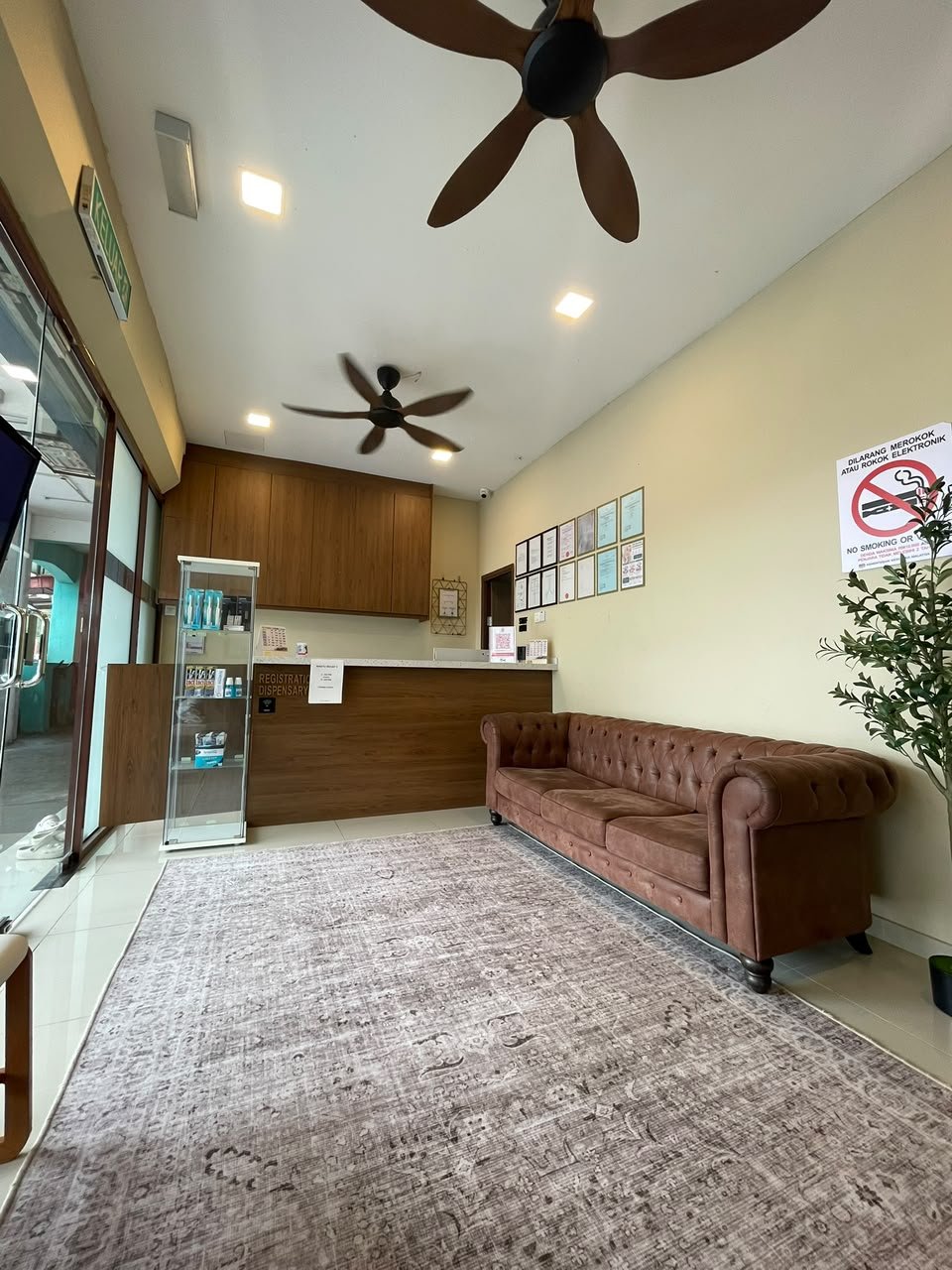 AN NAJAH reception desk with timber finishes and a brown sofa