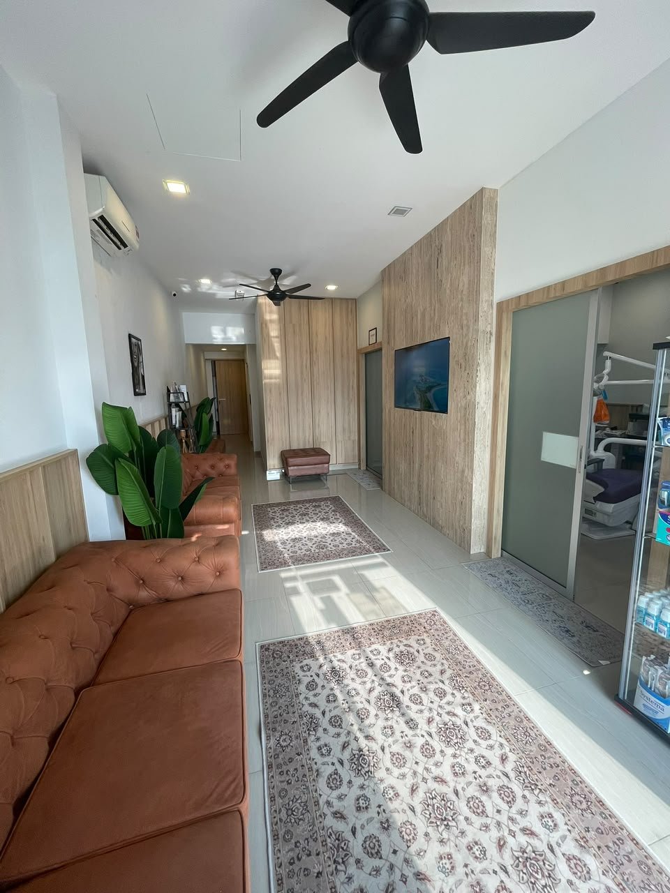 AN NAJAH waiting area with brown sofas, plants and timber partitions
